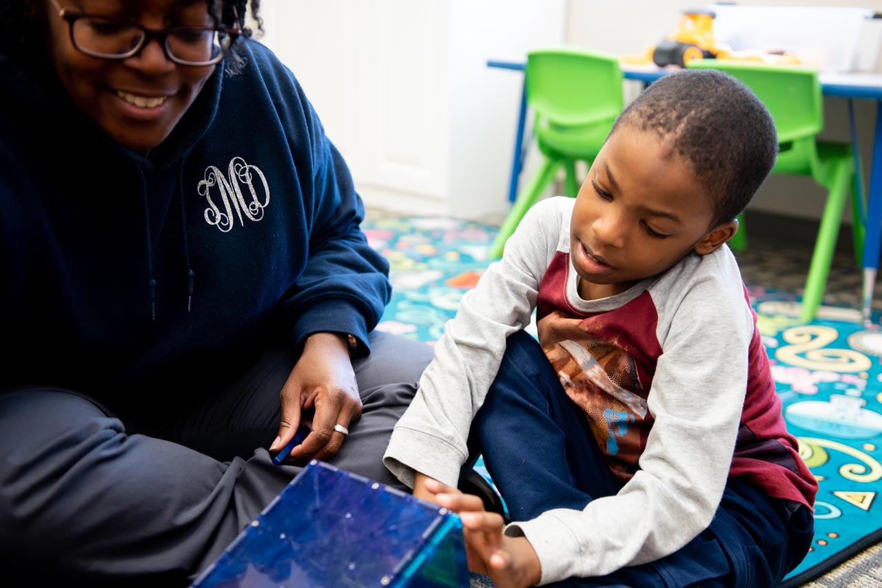 Young boy plays with teacher at Carolina Therapeutics special needs preschool